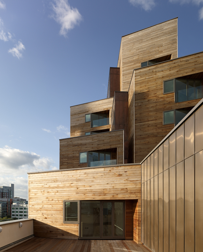 WATERMANS PLACE GRANARY WHARF LEEDS CZWG TIMBER BALCONY PLANES DETAIL WITH COPPER CLADDING LATE AFTERNOON